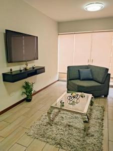 a living room with a couch and a coffee table at Departamento amplio y céntrico-Terrazas in San Antonio