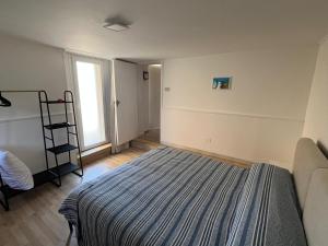 a bedroom with a bed and a ladder and a window at Camasileo in Ortona