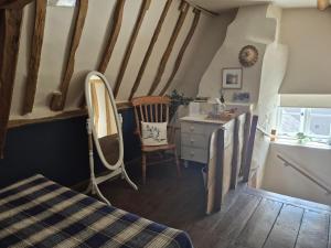 a attic room with a dressing table and a mirror at Wilde Escapes in Weston