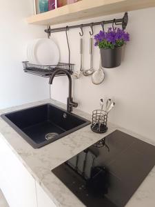 a kitchen with a sink and a counter with a sink at SUITEHOME Comfort Apartment near the Beach in Rimini