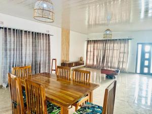 a dining room with a wooden table and chairs at Mulanje Vista House in Mulanje