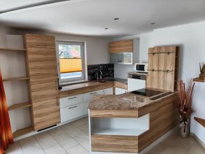a kitchen with white counters and wooden cabinets at Penthaus Appartement in Sankt Michael im Lungau