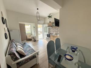 a living room with a couch and a glass table at Olive in Keramotí
