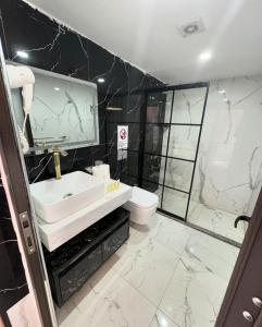 a bathroom with a sink and a shower and a toilet at Beauty Wadi Rum Luxury Camp in Wadi Rum