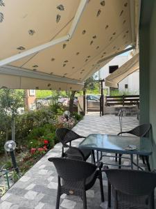 a patio with a table and chairs under an umbrella at Olive in Keramotí