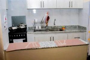 a kitchen with a sink and a counter top at Comfort and style in Nairobi