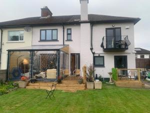 a house with a large deck in the yard at Private Studio near Dublin City in Dublin