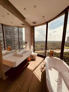a bathroom with two sinks and a tub and a toilet at Swanlake ecopark Hanoi-Calm homestay in Kim Quan