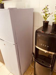 a refrigerator next to a microwave next to a computer at 1 Bhk in Abu Dhabi