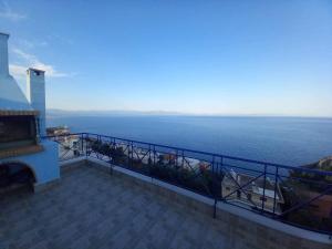 a view of the ocean from a balcony of a building at The Big Blue in Gythio +4 photos