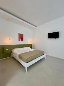 En eller flere senge i et værelse på Fata Morgana Guest Rooms