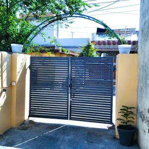 a gate in a fence with a plant at Peaceful Stay in Doon, Gateway to Mountains in Dehradun