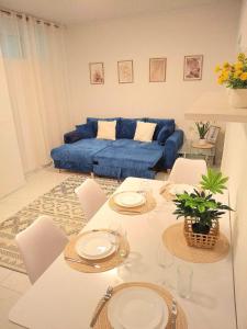a living room with a table and a blue couch at Family Design Apartments Neunkirchen - 2 rooms Apartment 5 in Neunkirchen