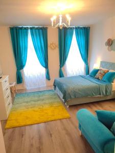 a bedroom with two beds and blue curtains at Family Design Apartments Neunkirchen - 2 rooms Apartment 5 in Neunkirchen