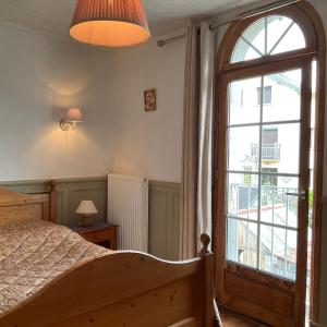 a bedroom with a bed and a large window at Gite les Flots Bleus in Jullouville-les-Pins