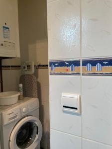 a kitchen with a washer and a washing machine at Gite les Flots Bleus in Jullouville-les-Pins