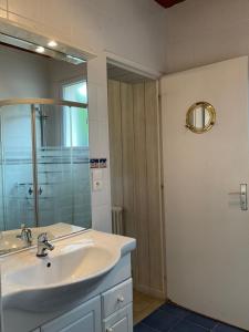 a bathroom with a sink and a mirror at Gite les Flots Bleus in Jullouville-les-Pins +17 photos