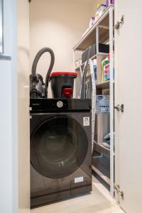 a washer and dryer in a kitchen with a pantry at Luxury 1 Bedroom Apartment with partial Burj Khalifa View by Delujo Stays in Dubai +58 photos