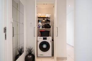 a washer and dryer in a hallway of a bathroom at Luxury Two Bedroom Apartment with City & Pool View by Delujo Stays in Dubai