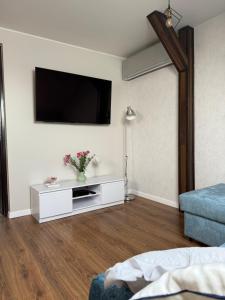 a living room with a tv on a wall at Apartament na poddaszu in Sandomierz