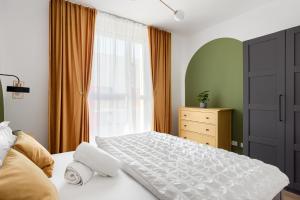a bedroom with a white bed and a window at Sika Nobless Apartment - cazare premium Arad - self check-in in Arad