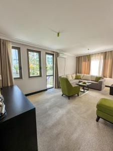 a living room with a couch and a table at Swiss Holiday Hotel by KUNDAKCI GROUP in Budva