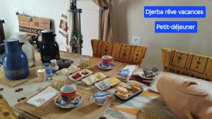a table with food and cups on top of it at Maison Bohème Suite Fatima in Midoun