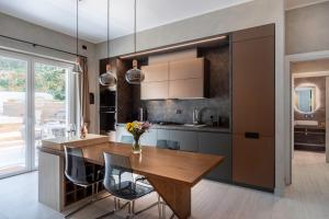 a kitchen with a wooden table and some chairs at Pool & Spa Deluxe in Rome