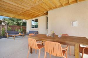 a wooden table and chairs on a patio at Colorful house with Amazing Backyard in Coachella