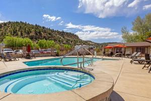 a pool at a resort with a mountain in the background at Best Western East Zion Thunderbird Lodge in Mount Carmel Junction