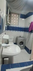 a small bathroom with a sink and a toilet at Sidi mahrsi Nabeul in Nabeul