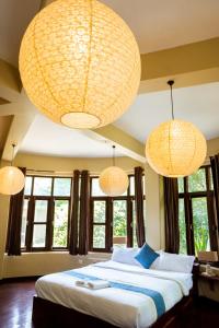 een slaapkamer met een groot bed met 3 verlichting bij Krazy Gecko Resort in Pokhara +37 foto's