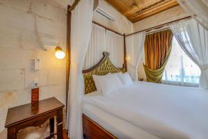 Postel nebo postele na pokoji v ubytování MDC Cave Hotel