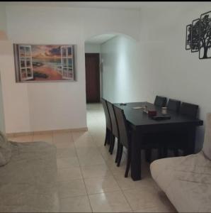 a dining room with a black table and chairs at Marina Puerto Luxurious apartment in Tetouan