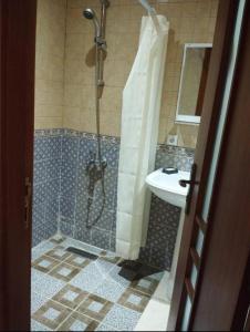 a bathroom with a shower and a sink at Marina Puerto Luxurious apartment in Tetouan