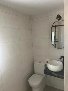 a white bathroom with a toilet and a sink at casa rural El Valle del Calar in Riópar