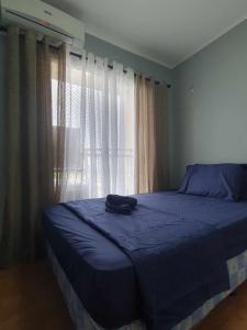 a bedroom with a blue bed and a window at Sanremo Oasis South Road Property Unit 4434 in Cebu City +12 photos