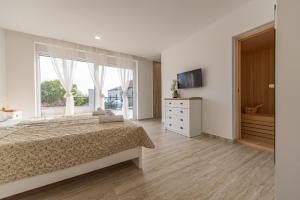 A television and/or entertainment centre at Seaview Villa A`More with heated pool