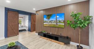 a living room with a tv on a wall at Chicago Vibe Heated Pool 5BR 2BTH in Miami