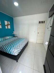 Un dormitorio con una cama y una puerta. en Azul caribe 101, en Santa Marta