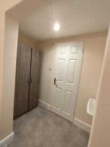 an empty bathroom with a door and a urinal at En-Suite Double-Bedroom in the Heart of Salford Manchester CR2 Perfect for Short Stays in Manchester