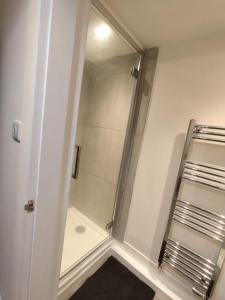 a shower with a glass door in a bathroom at En-Suite Double-Bedroom in the Heart of Salford Manchester CR2 Perfect for Short Stays in Manchester