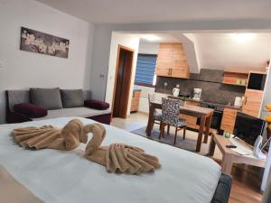 a room with a bed with a swan decoration on it at Apartments & Rooms Ramljak in Korenica