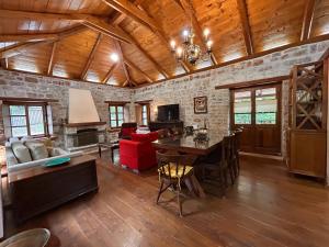 a living room with a wooden ceiling and a table at Villa Acroria in Karpenisi in Karpenisi