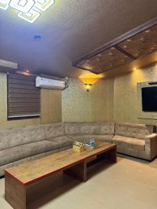 a living room with a couch and a table at KORAMANGALA SUITEs in Bangalore +89 photos