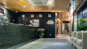 a lobby of a restaurant with a counter with flowers at Rian Hotel in Seoul