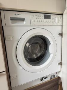 a white washing machine sitting in a cabinet at CAL Apartments in Duisburg +5 photos