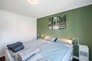 a bedroom with a large bed with towels on it at Zum alten Wald in Zell am Harmersbach