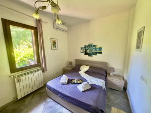 a bedroom with a bed with towels on it at Villetta di Sara tra Arezzo, Siena, Firenze e il Chianti in San Giovanni Valdarno