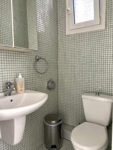 a bathroom with a sink and a toilet at Diamond Maisonette in Kavála